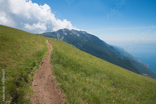 footpath at Monte Baldo summit with view to mountains and garda lake © SusaZoom