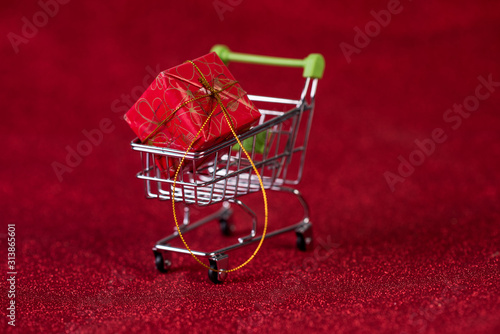 Red background and shopping trolley Shopping concept and trading