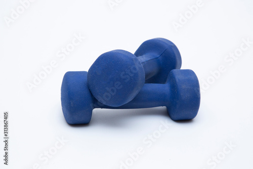 Blue dumbbells on a white background. The concept of sports.