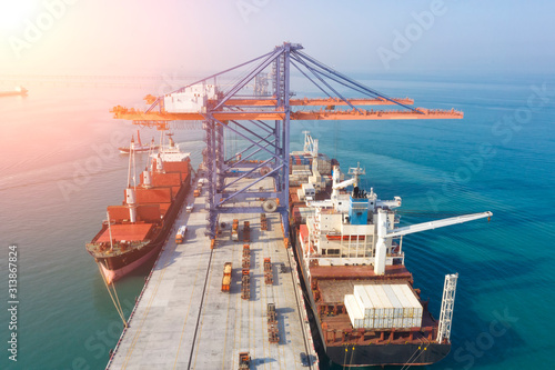 Container ship in export and import business and logistics. Shipping cargo to harbor by crane. Water transport International. Aerial view and top view.