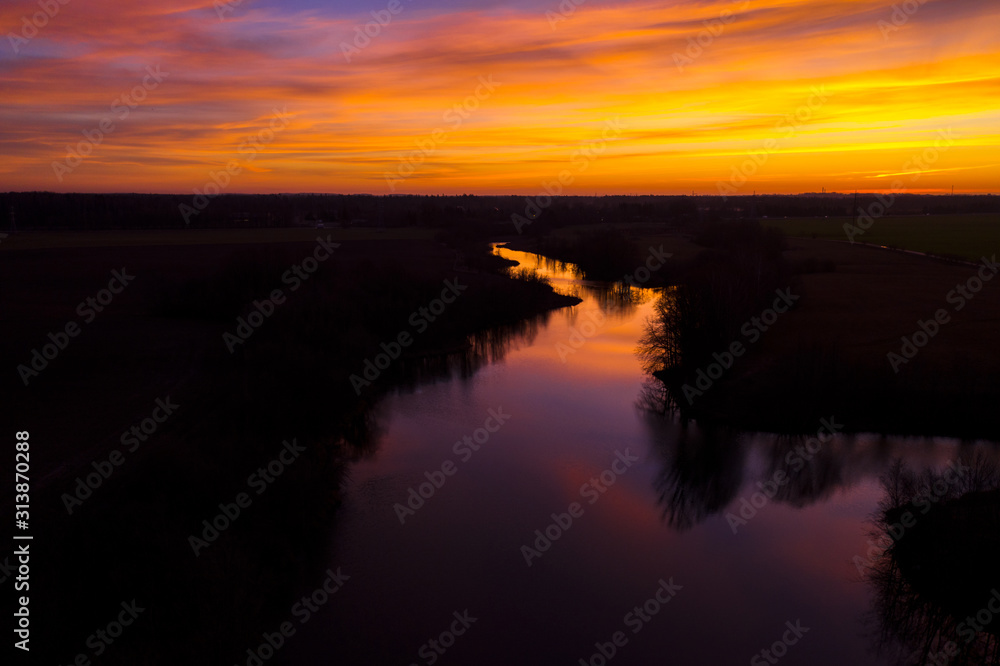 Aerial: Dramatic sunrise above the river
