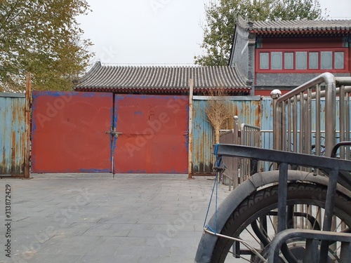 A traditional Chinese house or building with red closed gate in Beijing.