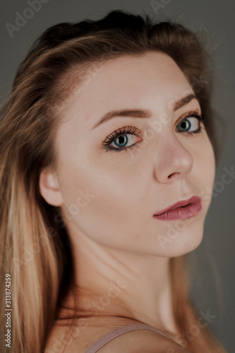 portrait of blonde girl with blue eyes and big bokeh