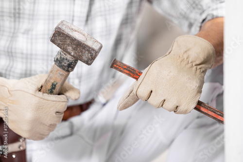 Workman or builder using a mallet and chisel photo