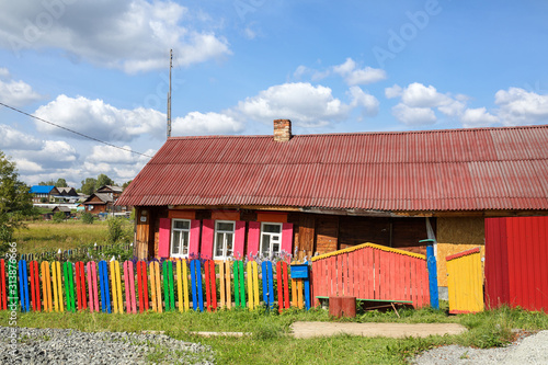 Brightly painted rickety wooden house. Village of Visim, Sverdlovsk region, Russia photo