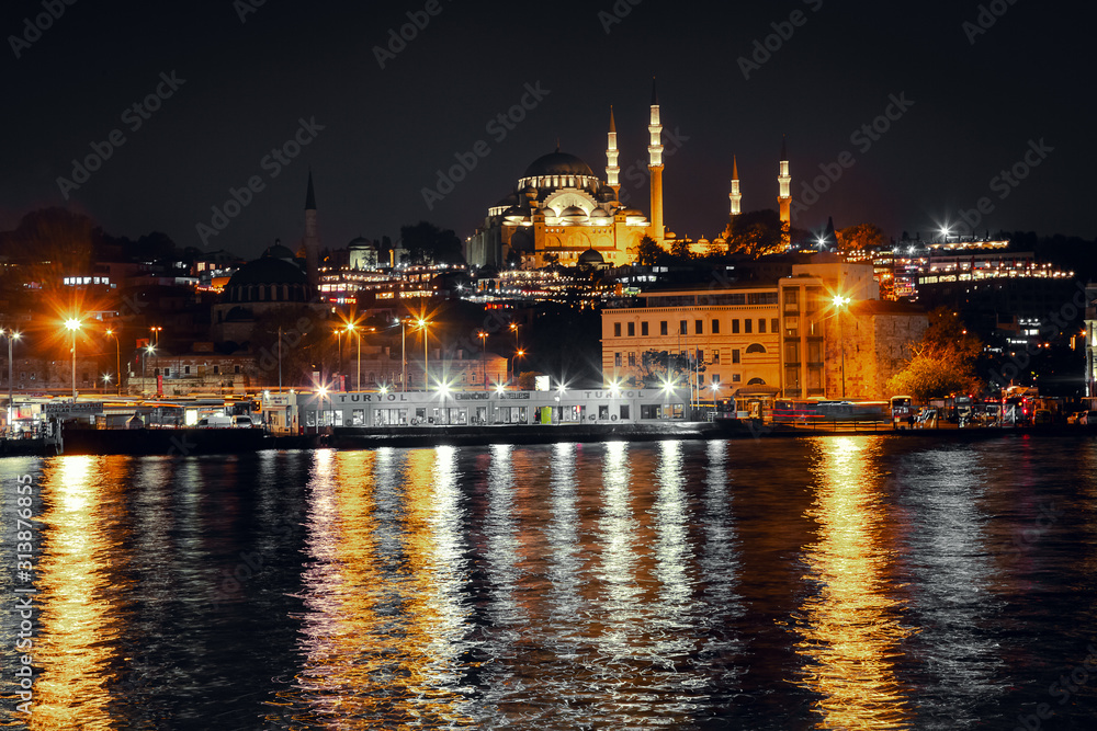 Evening view of the Golden Horn Bay with the Eminonu Pier on the background of the Suleymaniye Mosque.