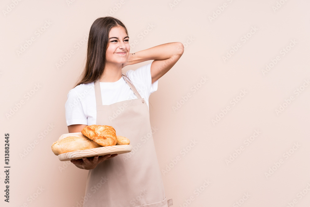 Young caucasian baker woman isolated touching back of head, thinking and making a choice. Young caucasian baker woman isolated touching back of head, thinking and making a choice.