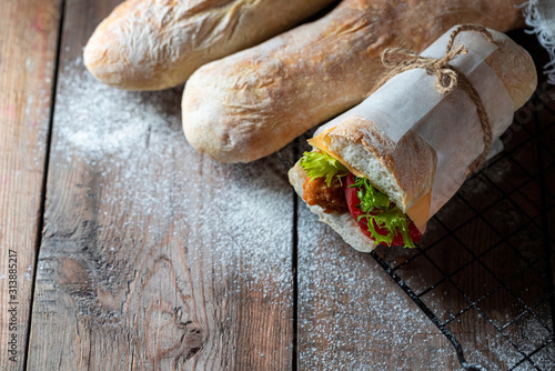 Sourdough homemade bread. Italian ciabatta panini sandwich with chicken and tomato.