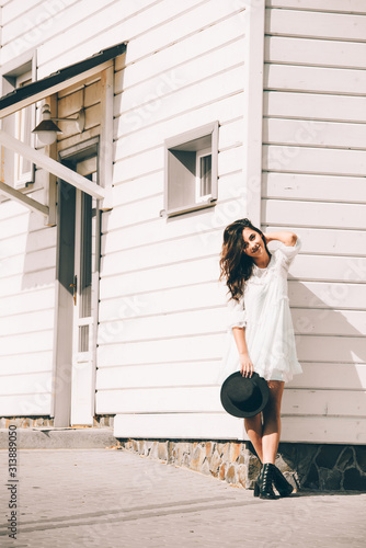 lifestyle fashion portrait of young stylish hipster woman walking on the street.