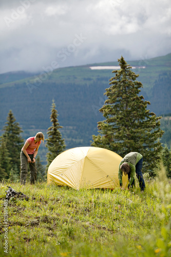 One man and one woman making camp wile backpacking near Andrews Lake, Molas Pass, on the way to Crater Lake by the Twighlight Peaks. San Juan Mountains, Weminuche Wilderness, CO photo