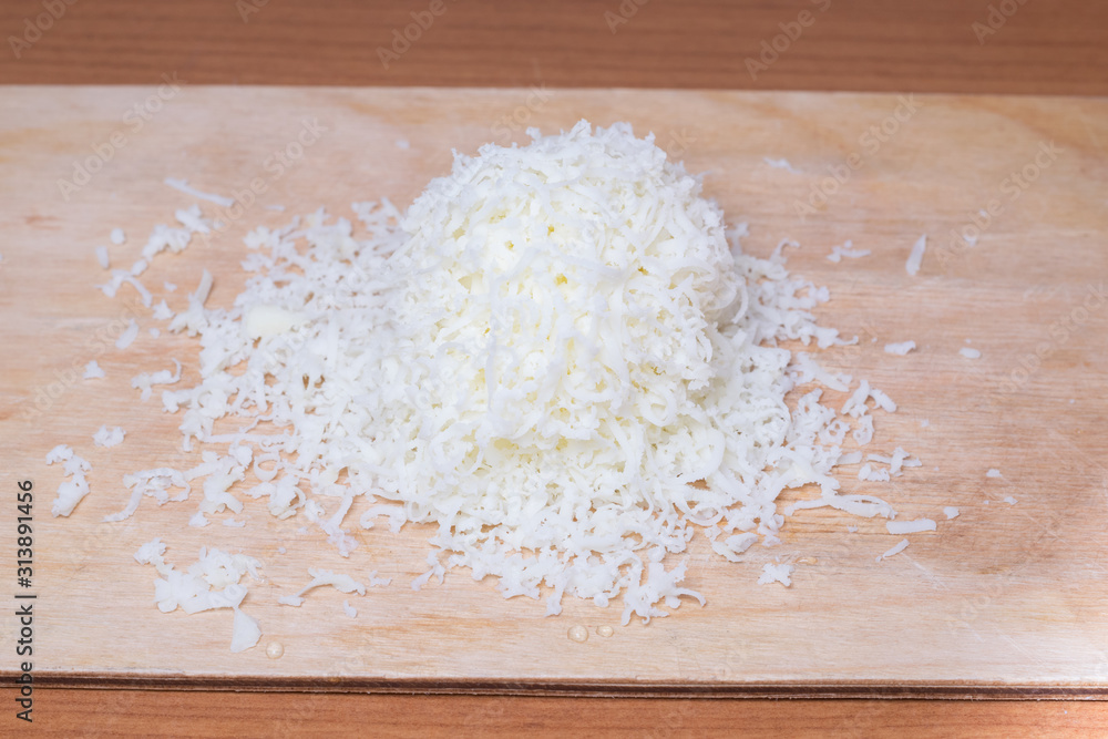 Organic Shredded Sharp Cheese on a Cutting Board Organic Shredded Sharp Cheese on a Cutting Board