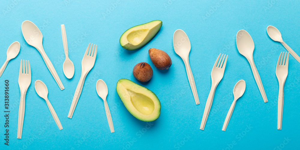 Eco plastic of avocado seeds isolated on blue background Eco plastic of avocado seeds isolated on blue background