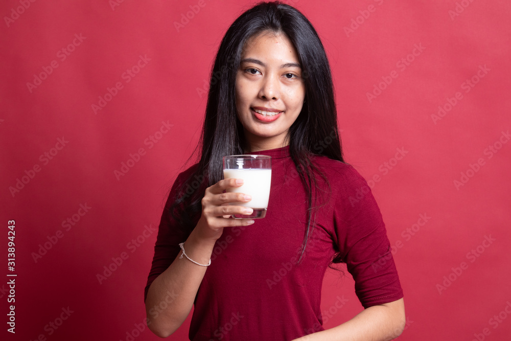 Healthy Asian woman drinking a glass of milk. Healthy Asian woman drinking a glass of milk.