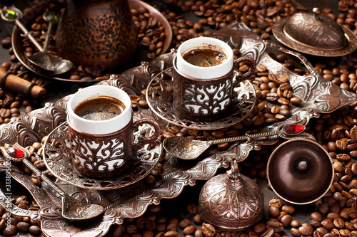 Traditional Turkish coffee in traditional copper cups on dark table