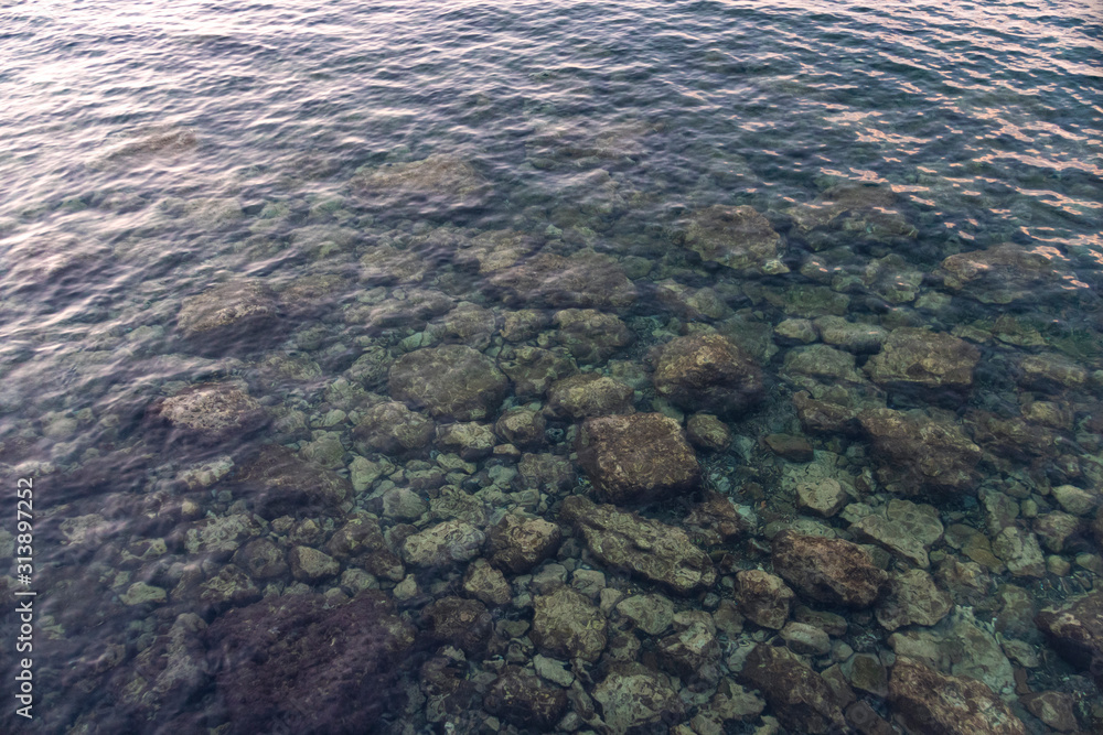 stone bottom under the extremely clear water of the sea stone bottom under the extremely clear water of the sea