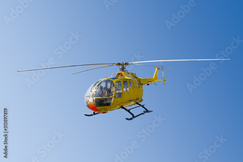 Flying yellow rescue helicopter