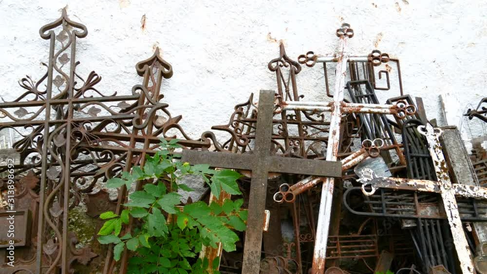 The group of metal fence lying on the wall of the cemetery The group of metal fence lying on the wall of the cemetery