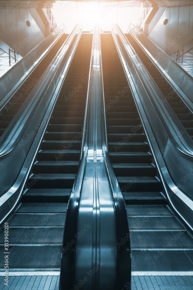 Mechanical escalator in the international airport or modern subway train station Mechanical escalator in the international airport or modern subway train station