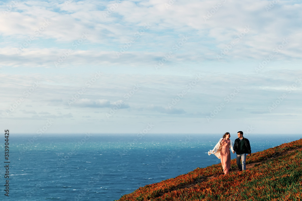 a romantic walk of a couple in the love of the ocean shore a romantic walk of a couple in the love of the ocean shore