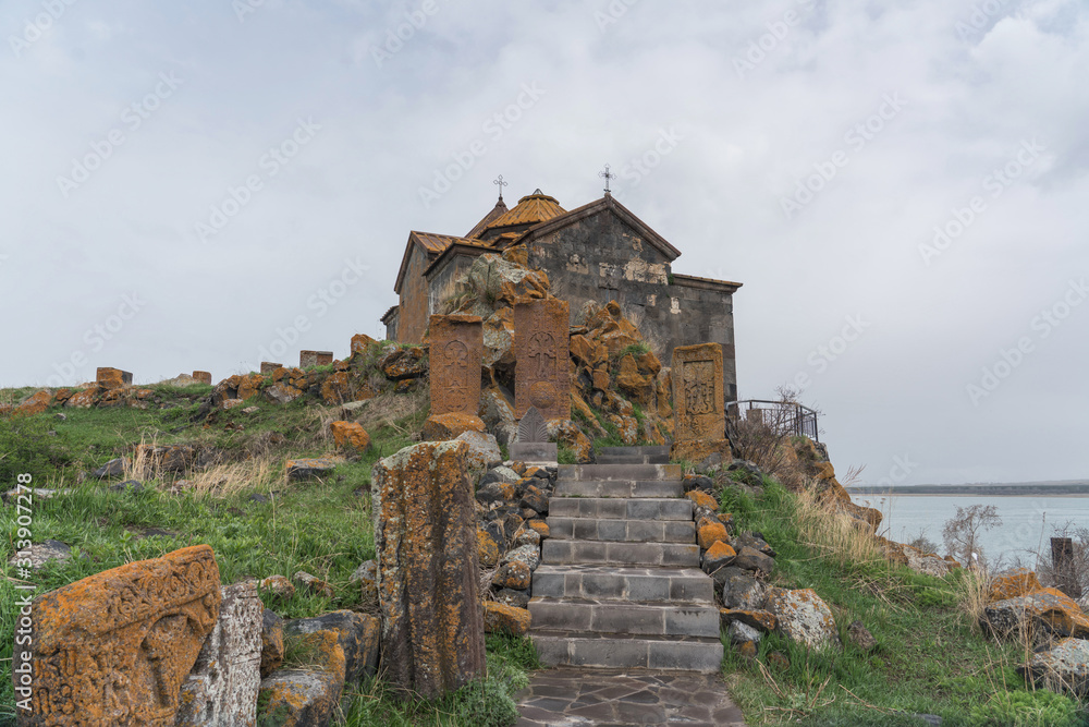 Ancient stone church with lichen-covered walls on a hill