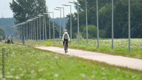 Cyclist in training, bike path near Polderbann runway photo