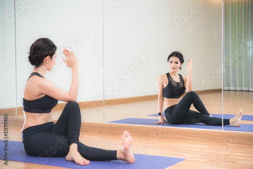 Attractive young beautiful Asian woman doing yoga exercise 