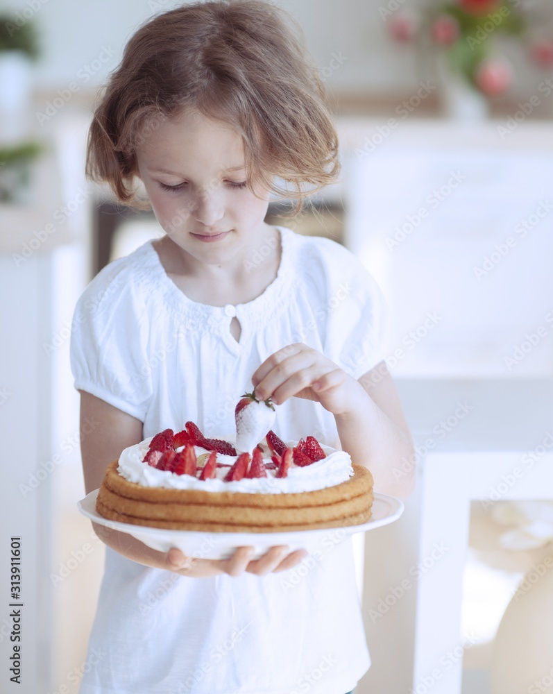 Young girl with cake and strawberries
