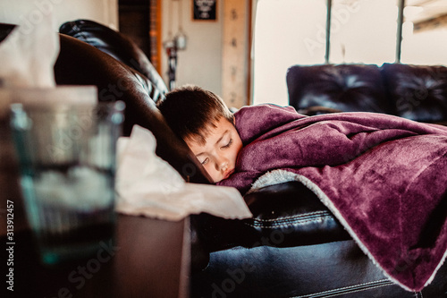 Young boy napping not feeling well photo