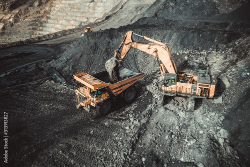 Excavator Loading Coal Truck from Aerial View photo