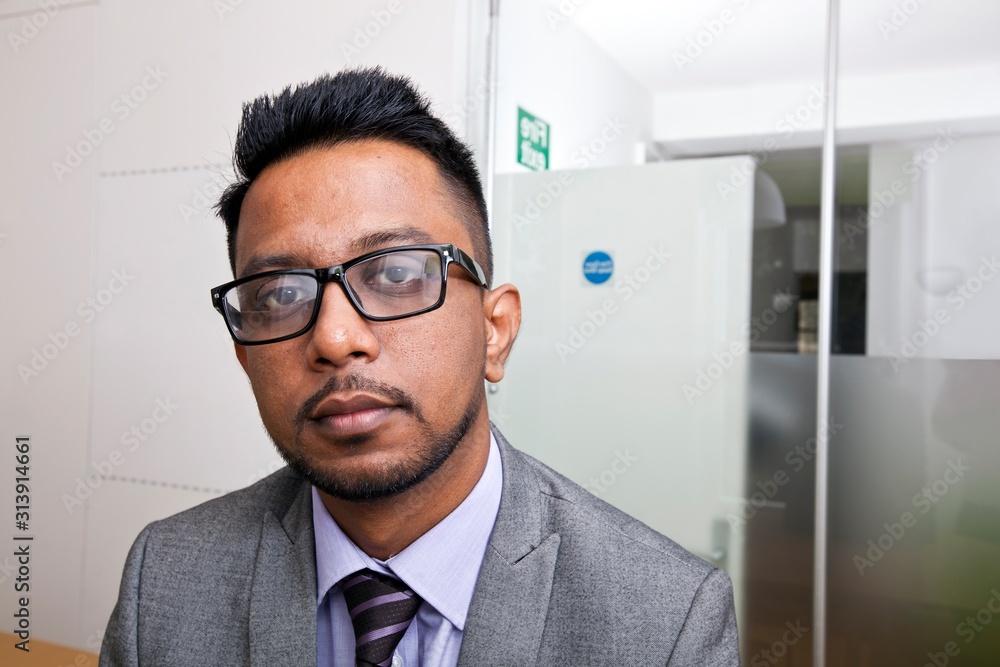 Close-up portrait of Indian Businessman wearing glasses with beard Close-up portrait of Indian Businessman wearing glasses with beard