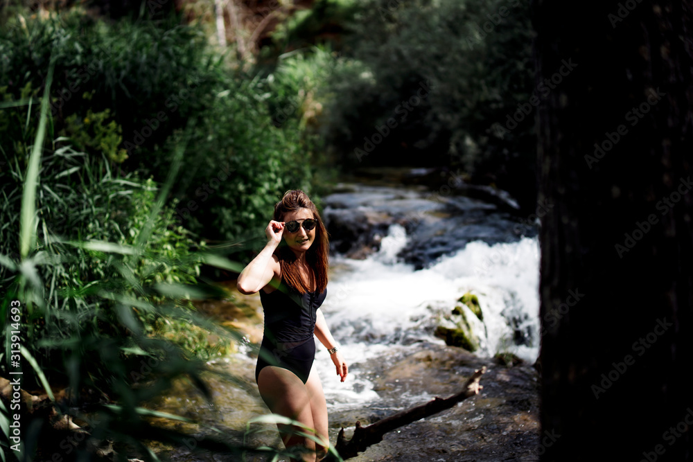 Blond woman bathing in beautiful river waterfall. Blond woman bathing in beautiful river waterfall.