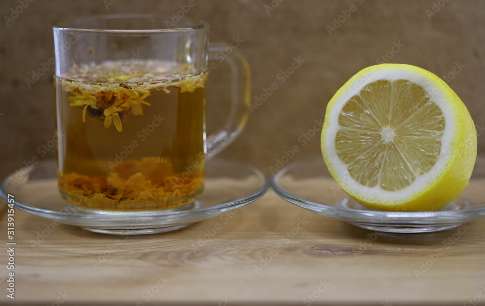 tea in a glass, lemon on a plate tea in a glass, lemon on a plate