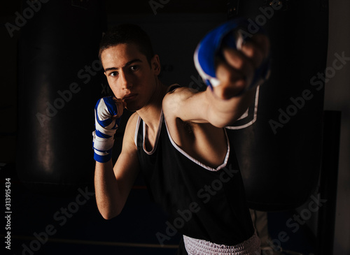 Young boxer practicing the left jab movement. photo