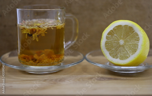 tea in a glass, lemon on a plate