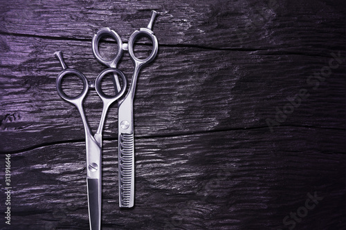 hairdressing different scissors isolated on black wooden