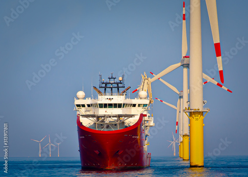 Quadro su tela Offshore support vessel ready to deploy walk to work gangway  at wind turbine as