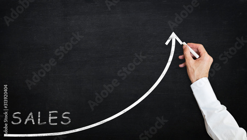 chalk drawing sales growth graph withchalk and handdrawing on the chalkboard photo