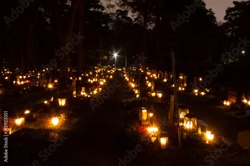 Christmas night at the Hietaniemi cemetery in Helsinki with Christmas lights, lanterns and candles that are traditionally lit in the cemetery on Christmas night in Finland.