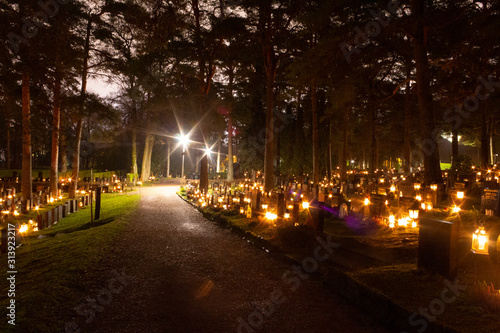 Christmas night at the Hietaniemi cemetery in Helsinki with a path  Christmas lights  lanterns and candles that are traditionally lit in the cemetery on Christmas night in Finland.