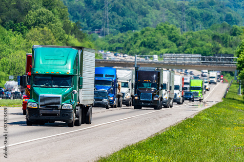 Green 18-Wheeler Leads Heavy Highway Traffic