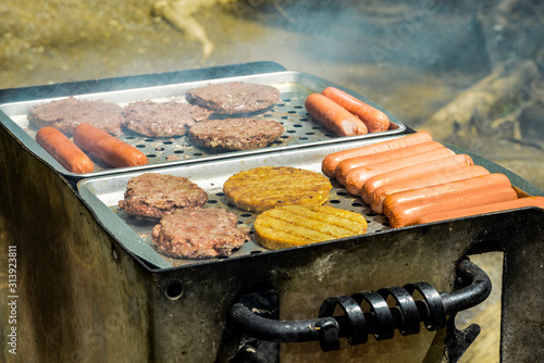 Hot Dogs and Burgers On Outdoor Grill photo