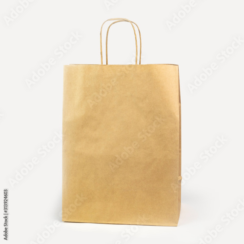 gray paper bag on a white background. concept of rejection of plastic bags. close-up.