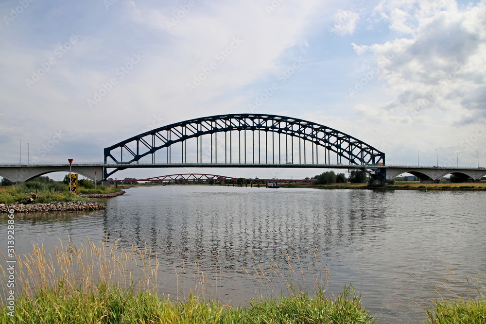 Old bridge of steel named Ijsselbrug over river IJssel to connect the province Gelderland to Overijssel at Zwolle in the Netherlands Old bridge of steel named Ijsselbrug over river IJssel to connect the province Gelderland to Overijssel at Zwolle in the Netherlands