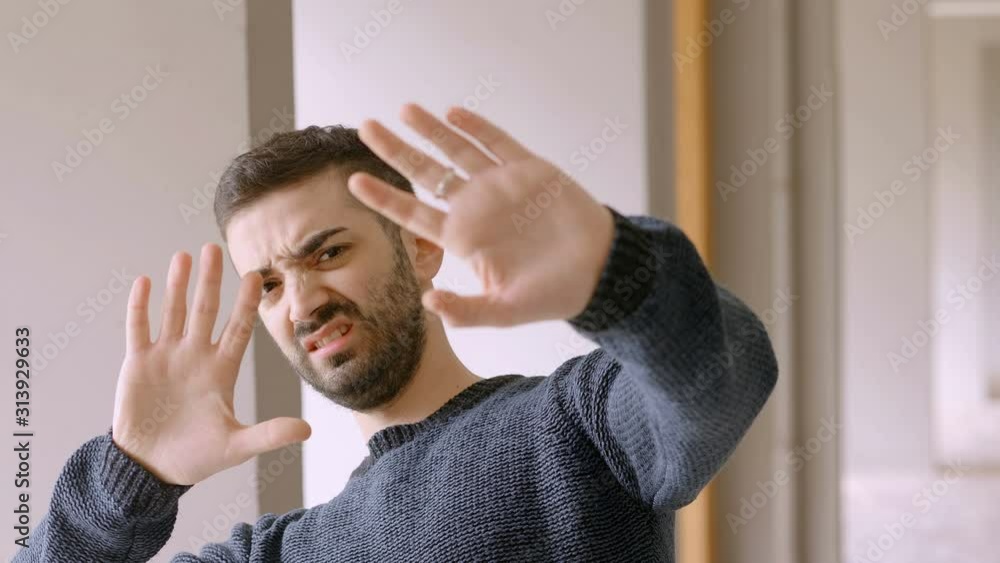 young serious man pushing something away disgusted young serious man pushing something away disgusted