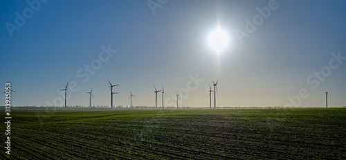 Nachhaltige Energiegewinnung: Windräder auf einem winterlichen Acker im Regionalpark Barnimer Feldmark bei Wesendahl photo