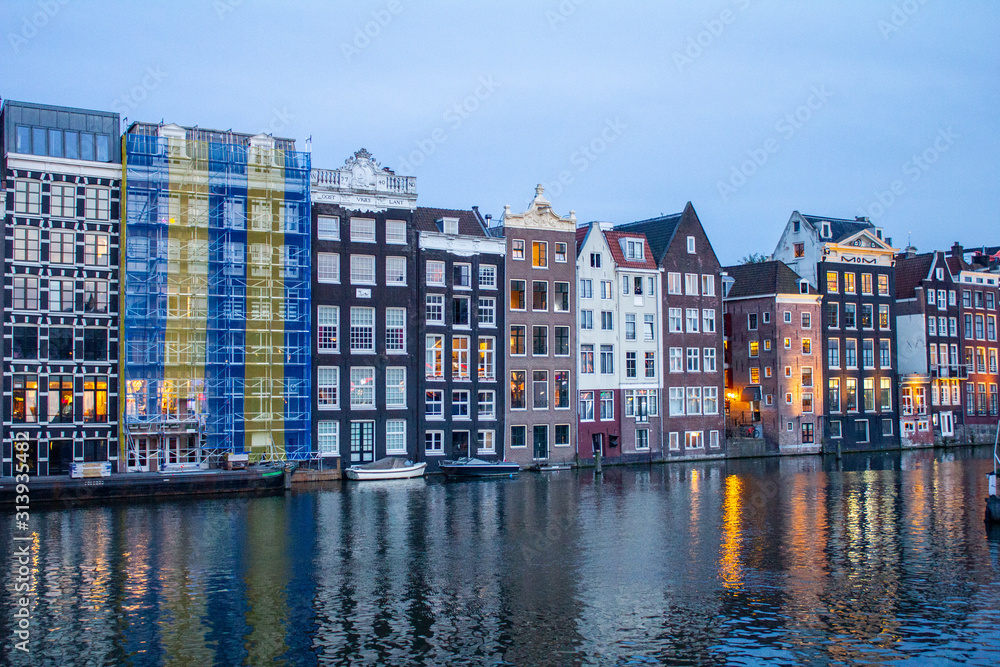 Amsterdam Canal with traditional old Houses and Trees.Landscape and culture travel, or historical building and sightseeing concept