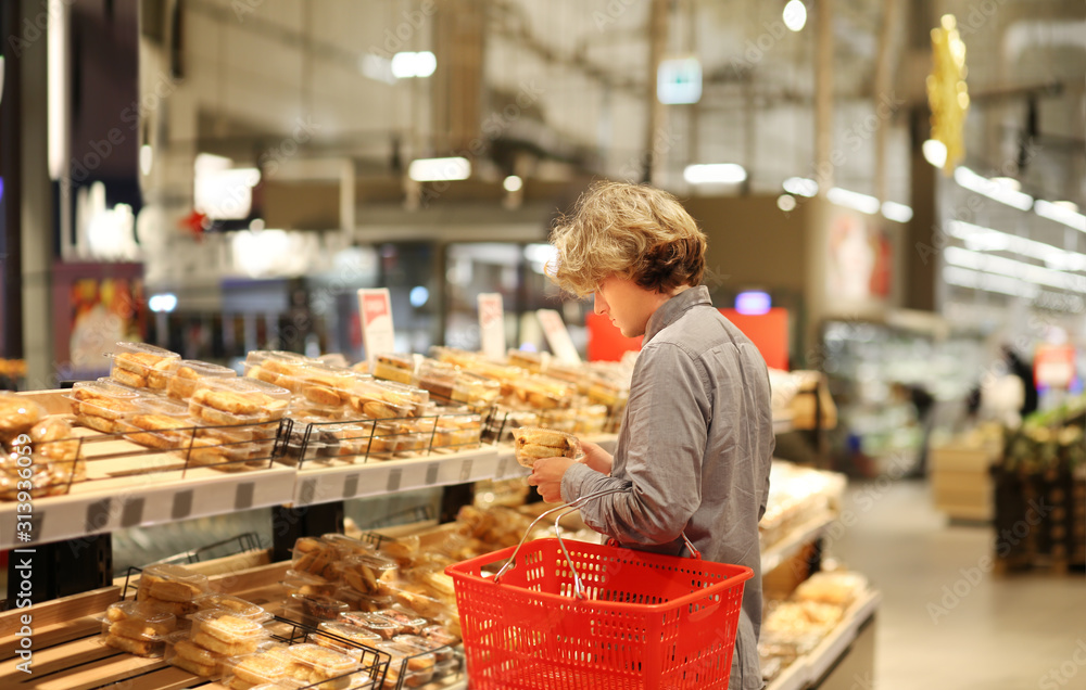 Teenager choosing bread  from a supermarket