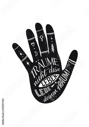 Lettering in a hand silhouette. Black and white graphics. German quote.  Don’t dream your life, live your dream. Träume nicht dein Leben, lebe deinen Traum.