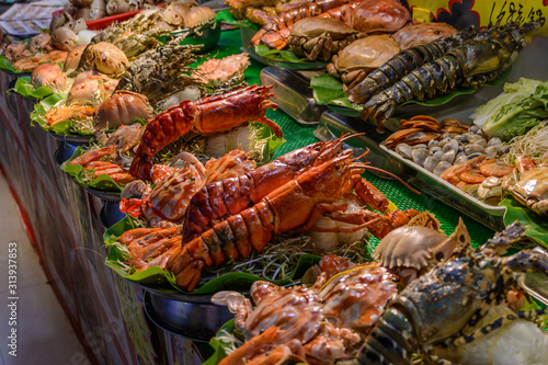 Chinese street food. Street trading. Chinese kinds of fresh seafood at an asian seafood market in Sanya, Hainan province, China. Inscription: name food.