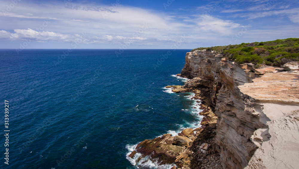 Australia's Royal National Park offers spectacular views from rocky cliffs above crashing surf and vibrant blue waters.